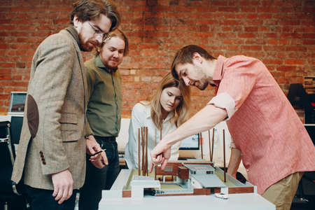 Architect group condemn with blueprints and layout design project at office