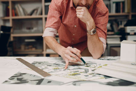 Architect with blueprints and layout design projectの写真素材