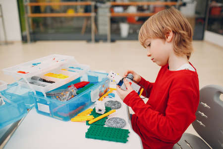 Little boy with robotic constructor assembling technical toy. Children Robotics constructor robotの写真素材