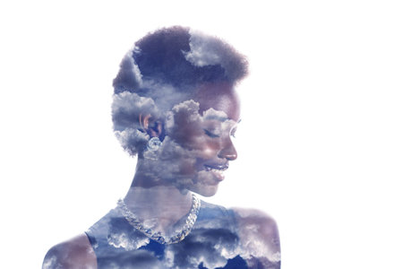 Multiple exposure image with clouds and sky inside positive smiling african american woman portrait....
