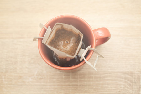 Coffee Drips in cup. Alternative brewing specialty coffee in paper filter bags.の写真素材