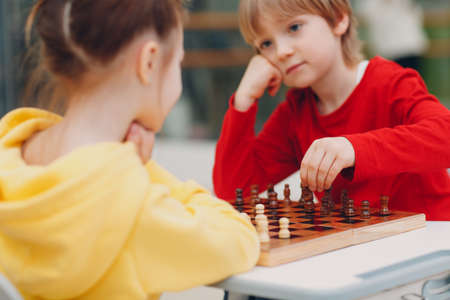 Little kids playing chess at kindergarten or elementary school.の写真素材