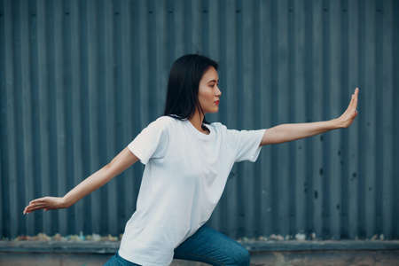 Asian young woman doing qigong exercise summer outdoor.の写真素材
