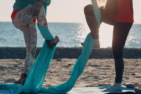 Aerial yoga on the beach. Healthy Womanの写真素材