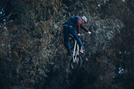 Professional young sportsman cyclist riding mini bike at skatepark
