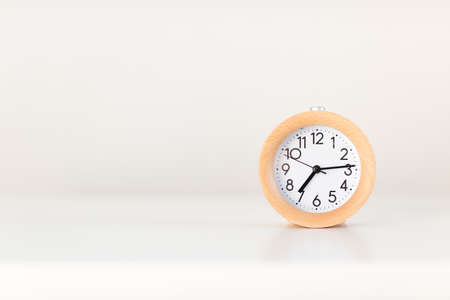 Alarm clock watch on white table background.
