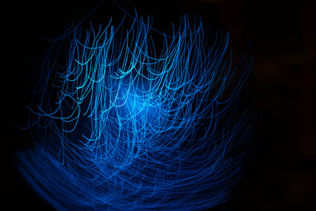 Blue abstract particles and lines with bokeh and blur in dark background.の写真素材