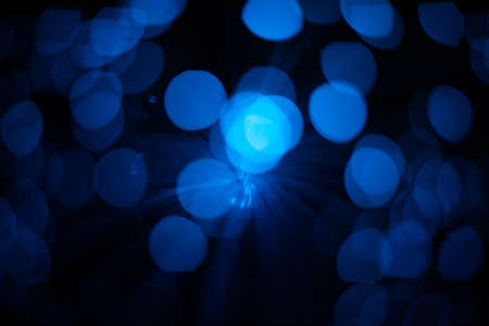 Blue abstract particles and lines with bokeh and blur in dark background.の写真素材