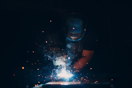 Welder welding metal construction on a workshopの写真素材