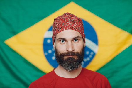 Bearded man in bandana against Brazilian flag background.の写真素材