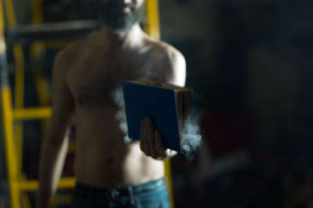 Man hold burning book in his hands
