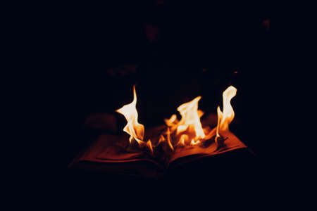 Book sheets flaming burns on dark background.の写真素材