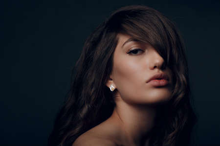Portrait of beautiful young brunette woman with healthy hair.の写真素材