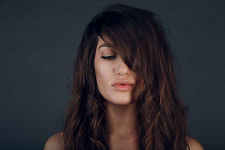Portrait of beautiful young brunette woman with healthy hair.の写真素材