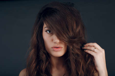 Portrait of beautiful young brunette woman with healthy hair.の写真素材