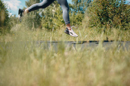 Runner woman in running shoes closeup of woman sporty legs. Female joggingの写真素材