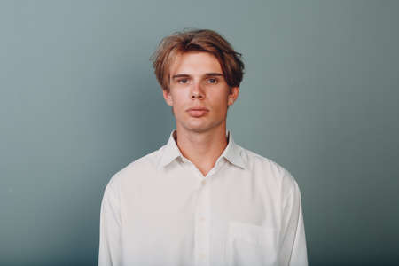 Portrait european young man serious portrait at studioの写真素材