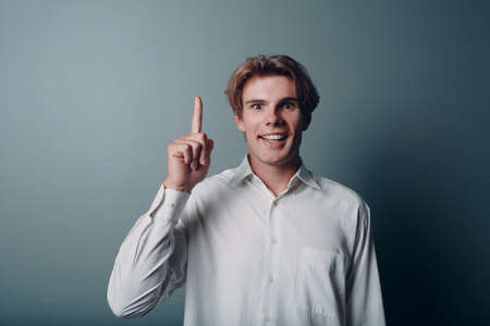 Young man pointing and forefinger index finger upの写真素材