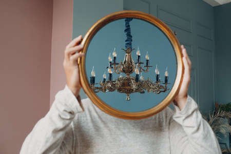 Portrait european young man with round mirror portrait at studio indoorの写真素材