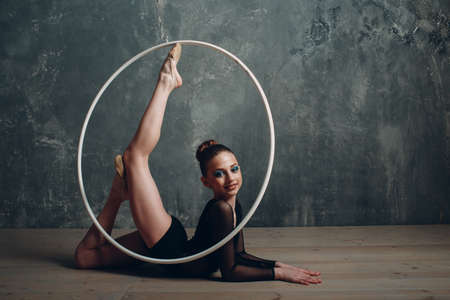 Young girl professional gymnast woman dance rhythmic gymnastics with ribbon at studio.の写真素材