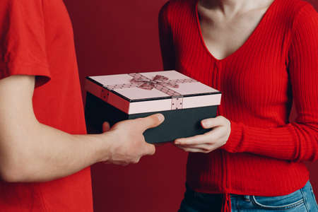 Valentine Day Gift. Happy Young Couple with Valentines Day Presentの写真素材