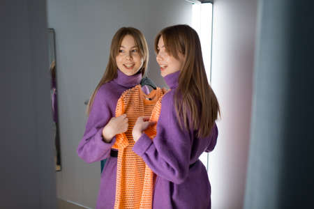 Young woman trying on clothes in dressing room storeの写真素材