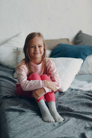 Little girl child in pink clothes portrait at homeの写真素材
