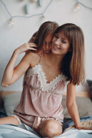Mother and little daughter child girl at home. Single parenting and motherhood.の写真素材