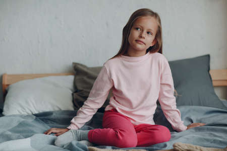 Little girl child in pink clothes portrait at homeの写真素材