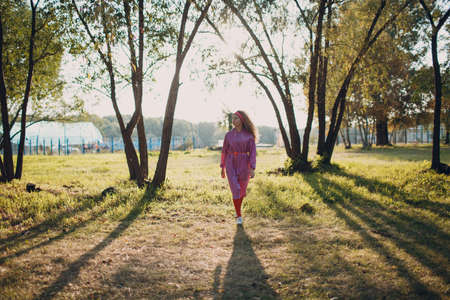 Young curly teenager woman with roller skates outdoorの写真素材