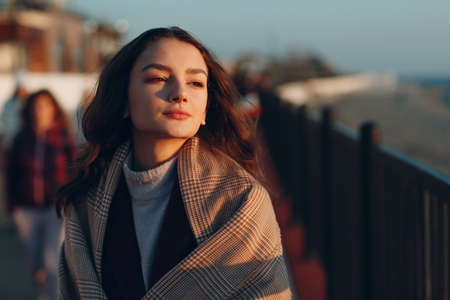 Young woman in coat at coast outdoorsの写真素材