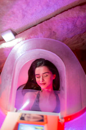 Young beautiful woman and beauty spa capsule.の写真素材