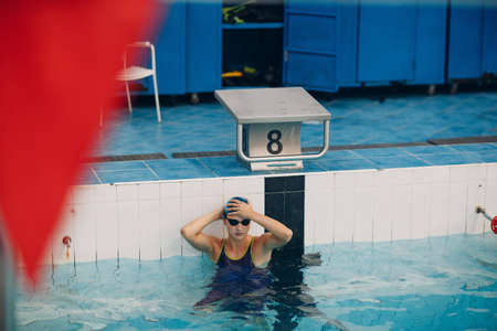 Young woman sporty professional swimmer swim in swimming poolの写真素材