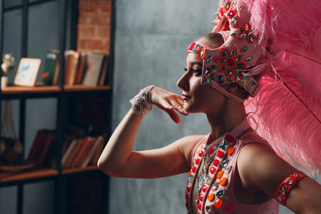 Woman in samba or lambada costume with pink feathers plumage.