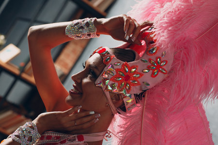 Woman in samba or lambada costume with pink feathers plumage.の写真素材