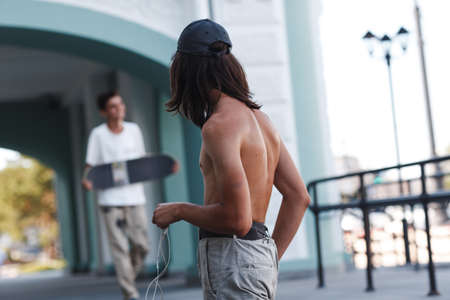 Young boy stay with skateboard in city.の写真素材