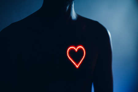 Adult man torso with heart shape on the chest. Healthy human heartの写真素材