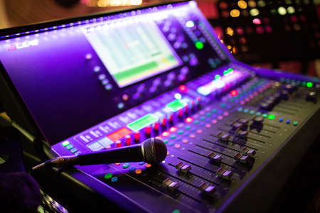 Mixing console, hand equalizing audio sound channels in night club.の写真素材