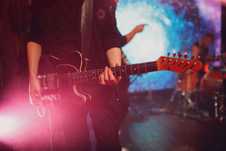 Closeup of a man hands strumming electric guitar.の写真素材