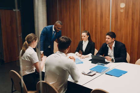 Businessman and businesswoman team mentor at office meeting. Business people different nationalities...