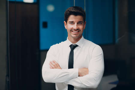 Portrait young man businessman in white shirt and tie smiling in office.の写真素材