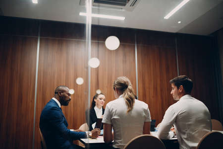 Businessmen and businesswomen team at office meeting. Business people group conference discussion sit at table with boss man and woman corporateの写真素材