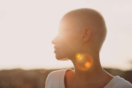 Portrait profile of young smiling millenial european short haired woman. Beautiful happy blonde girl outdoor. Summer fashion female clothing.の写真素材