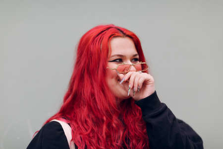 Plus size overweight fat body positive lgbtq woman with red hair and pink glasses.の写真素材