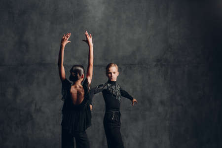 Couple in black dress dancing in ballroom dance rumbaの写真素材