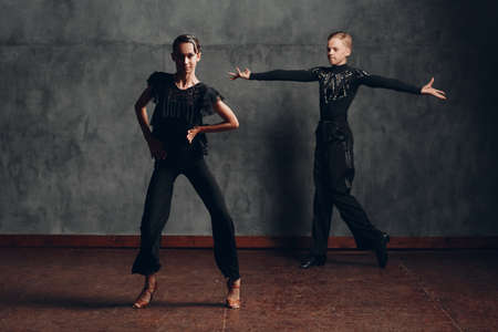 Young dancers male and female dancing in ballroom dance cha cha chaの写真素材