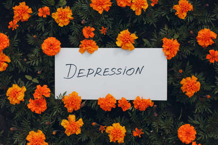 White sheet of paper with the word Depression on flower background.の写真素材