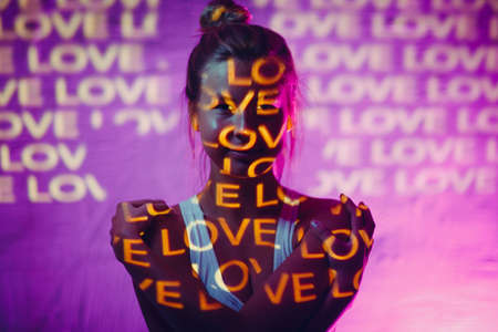 Young adult woman with word Love on her body.の写真素材