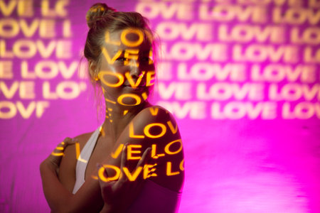 Young adult woman with word Love on her body.の写真素材