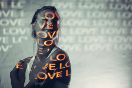 Young adult woman with word Love on her body.の写真素材